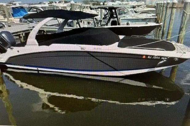 Slide: The Image of 2018 Four Winns HD270 OB boat docked in a marina. - 3