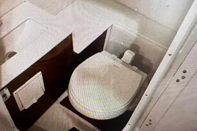 Slide: The Image of 2018 Four Winns HD270 OB boat interior with compact marine toilet. - 5