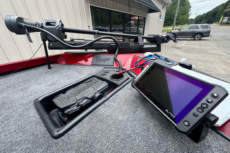 Slide: The Image of 2024 Bass Tracker RT178 boat with Lowrance electronics and trolling motor, parked outside a building. - 10