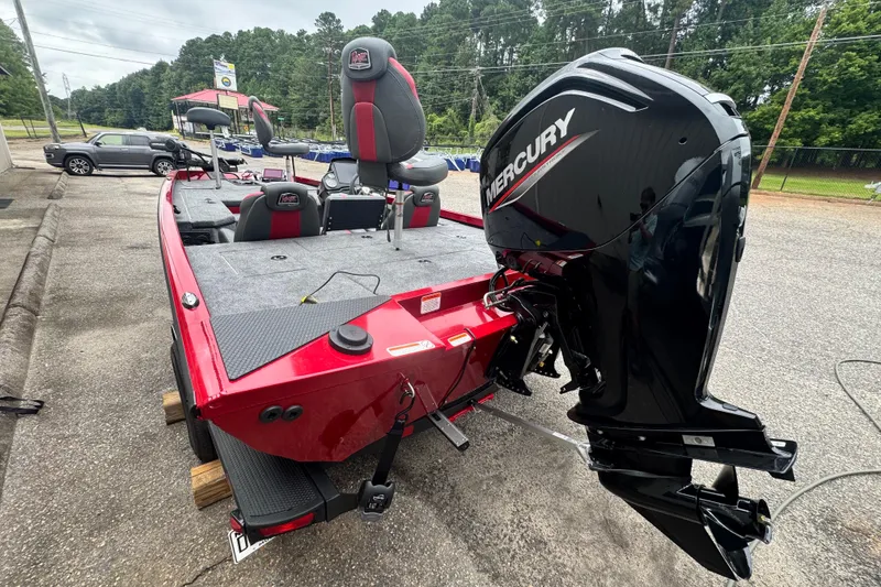 Slide: The Image of 2024 Bass Tracker RT178 boat with Mercury engine, parked outdoors on a cloudy day. - 17