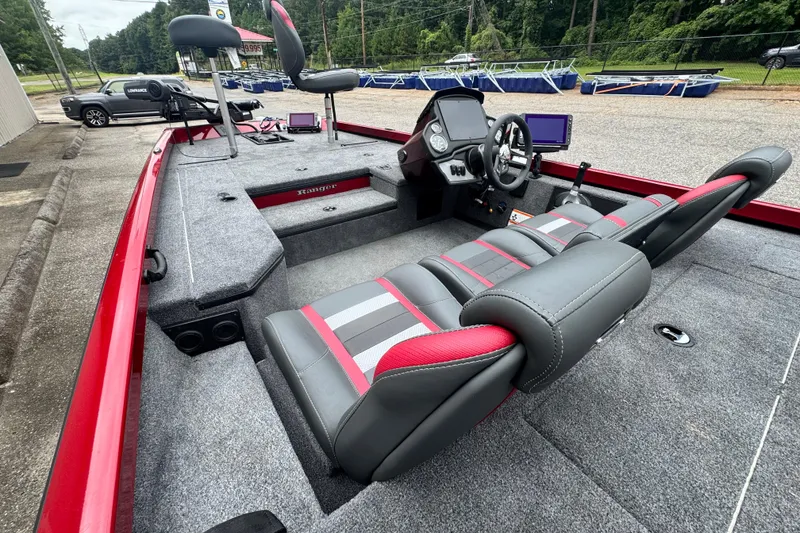 Slide: The Image of 2024 Bass Tracker RT178 boat interior with gray and red seating, steering console, and fishing seats. - 18