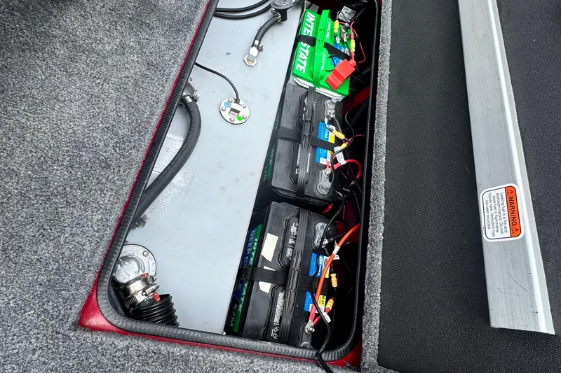 Slide: The Image of 2024 Bass Tracker RT178 boat battery compartment with multiple batteries and wiring. - 20