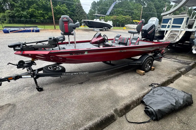 Slide: The Image of 2024 Bass Tracker RT178 boat on trailer, red color, parked outdoors. - 4