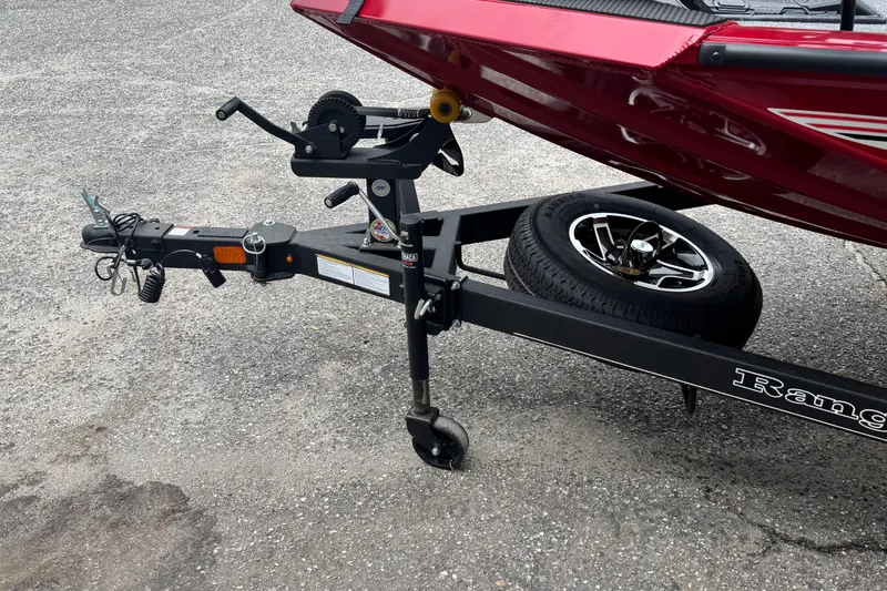 Slide: The Image of 2024 Bass Tracker RT178 boat trailer hitch and spare tire on asphalt. - 5