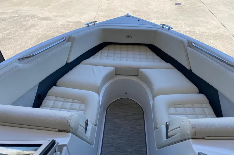 Slide: The Image of 2021 Cobalt R3 boat interior with white cushioned seating and sleek design. - 6
