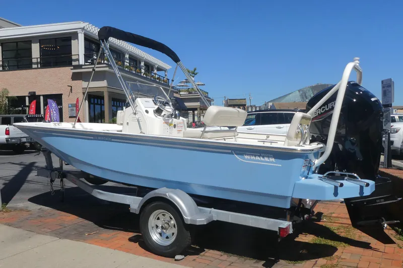 Slide: The Image of 2026 Boston Whaler 170 Montauk boat on trailer, displayed outdoors in a sunny setting. - 3