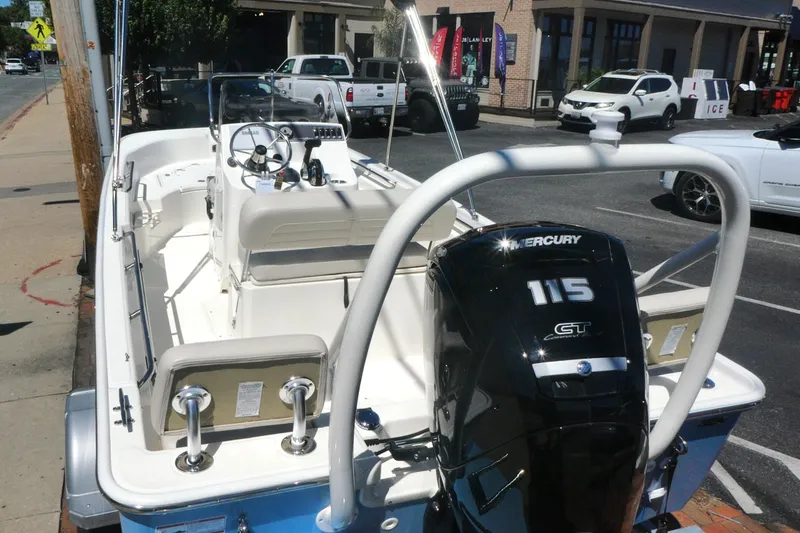 Slide: The Image of 2026 Boston Whaler 170 Montauk boat with Mercury 115 engine, parked on street. - 4