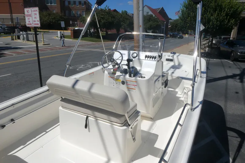 Slide: The Image of 2026 Boston Whaler 170 Montauk boat parked on urban street, showcasing interior and controls. - 6