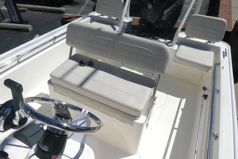 Slide: The Image of 2026 Boston Whaler 170 Montauk boat interior with steering wheel and seating. - 8