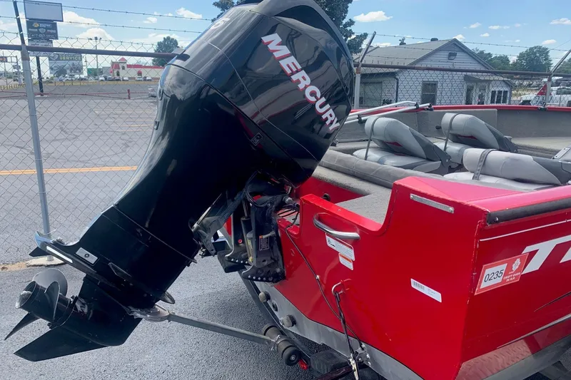 Slide: The Image of 2012 Tracker Pro Guide V-175 SC boat with Mercury outboard motor, parked outdoors. - 2