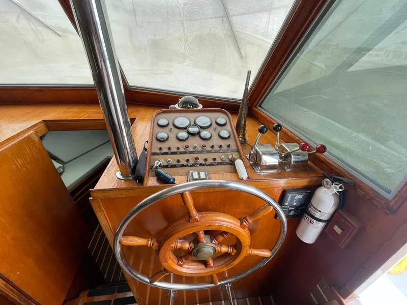 Slide: The Image of 1985 DeFever 40 Offshore Cruiser helm with wooden wheel and control panel. - 10
