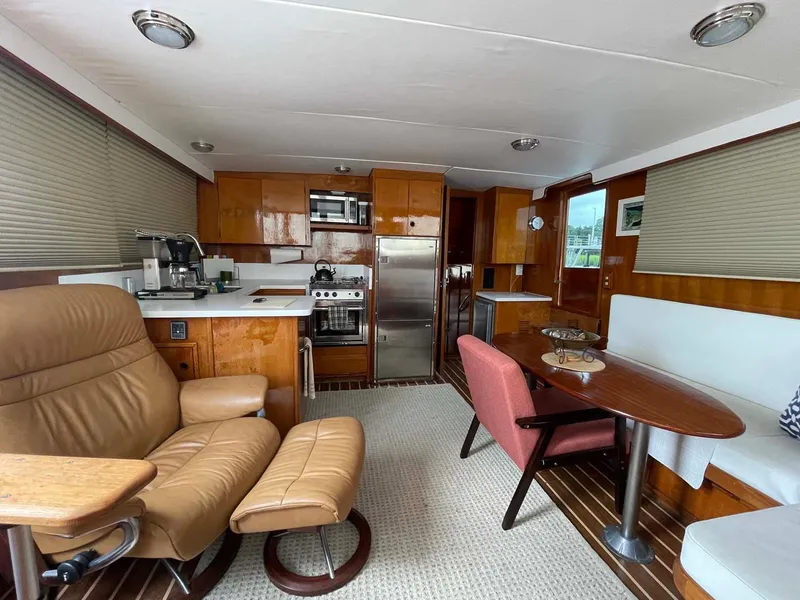 Slide: The Image of Interior of 1985 DeFever 40 Offshore Cruiser with modern kitchen and comfortable seating. - 12