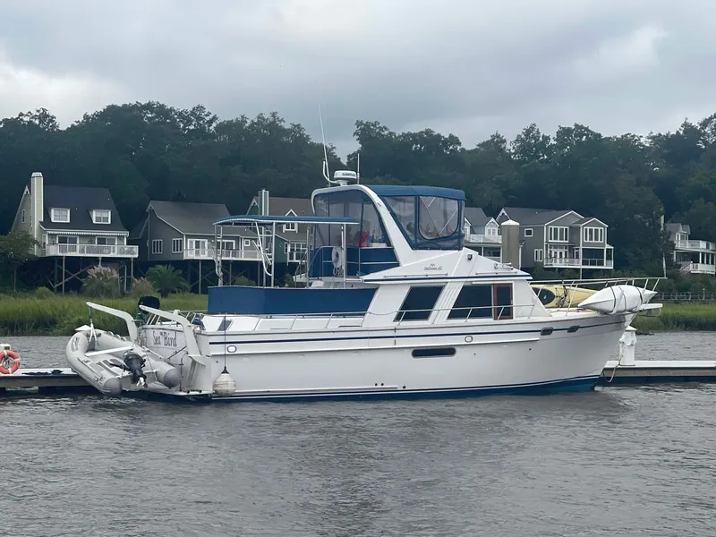 Slide: The Image of 1985 DeFever 40 Offshore Cruiser docked near waterfront homes. - 2