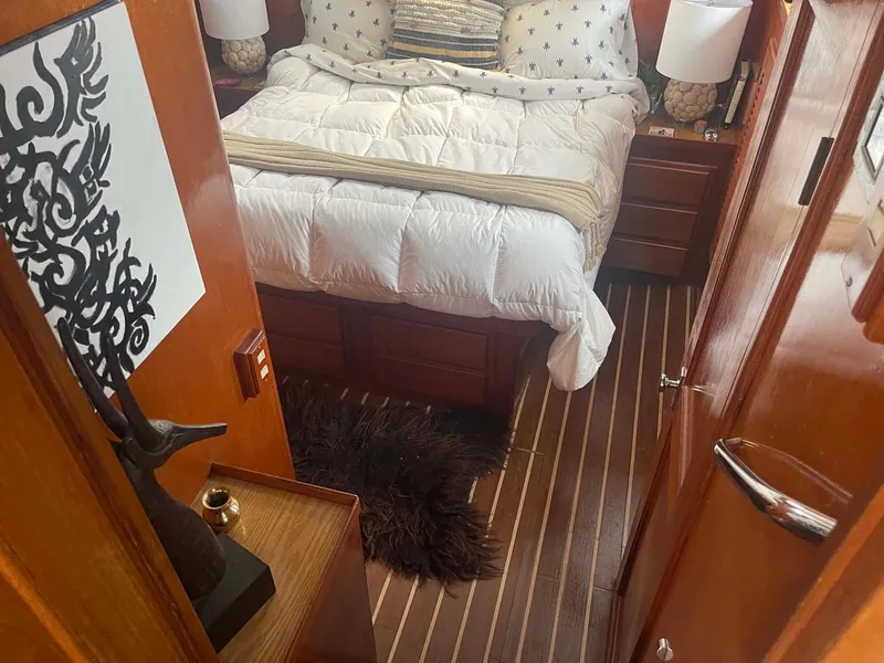 Slide: The Image of Cozy bedroom interior of 1985 DeFever 40 Offshore Cruiser with wood accents and plush bedding. - 21