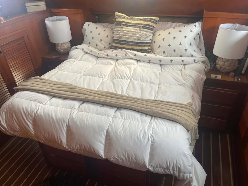 Slide: The Image of Cozy bedroom in 1985 DeFever 40 Offshore Cruiser with nautical decor and wooden accents. - 22