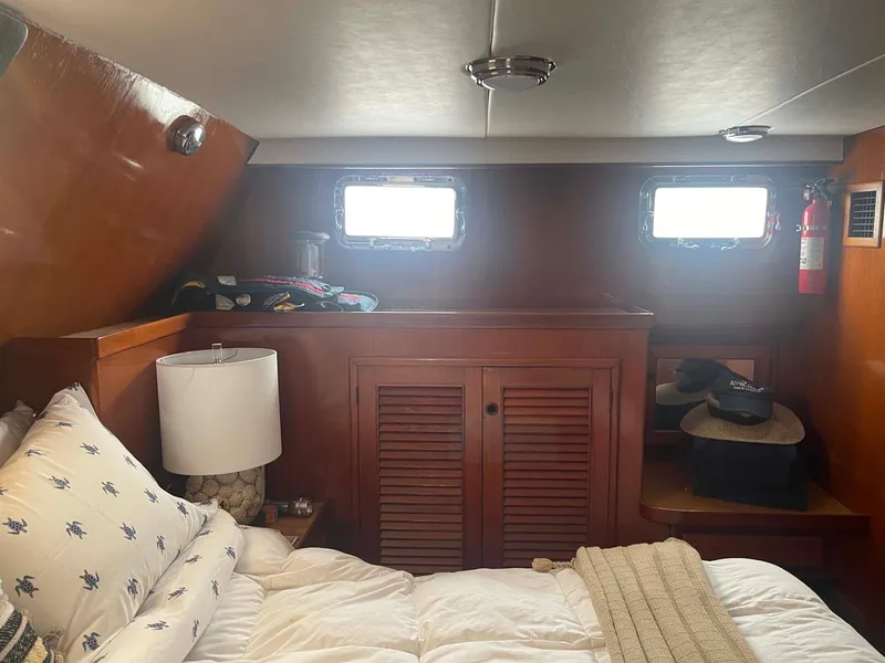Slide: The Image of Cozy cabin interior of 1985 DeFever 40 Offshore Cruiser with bed and wooden cabinetry. - 24