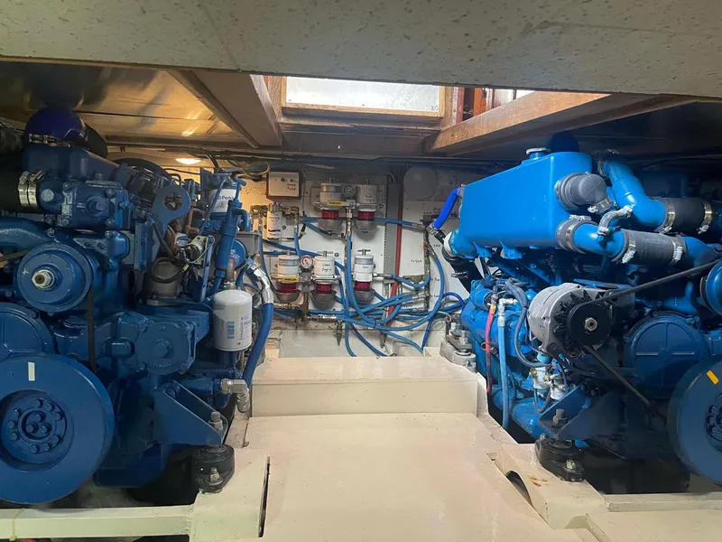 Slide: The Image of Engine room of 1985 DeFever 40 Offshore Cruiser with dual blue engines. - 28