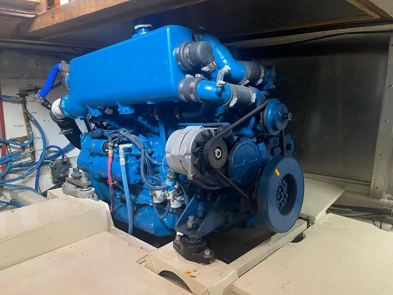 Slide: The Image of Engine of 1985 DeFever 40 Offshore Cruiser, painted blue, in a boat's engine room. - 29