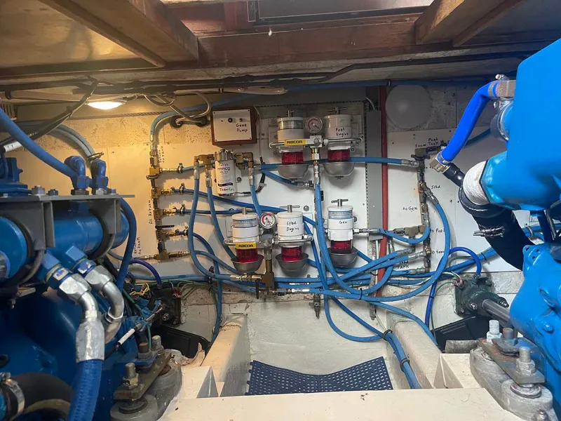 Slide: The Image of Engine room of 1985 DeFever 40 Offshore Cruiser with visible fuel lines and filters. - 31
