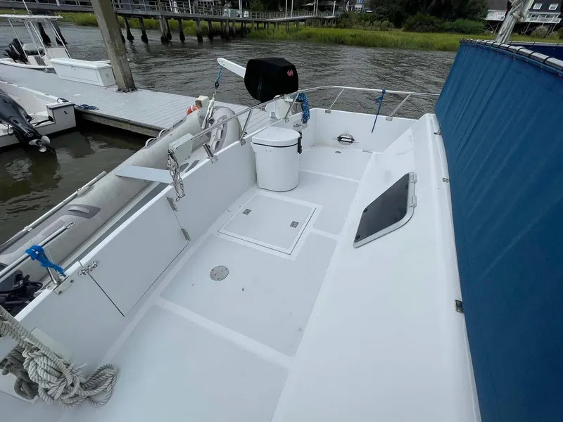 Slide: The Image of 1985 DeFever 40 Offshore Cruiser deck with railing, docked by the water. - 36