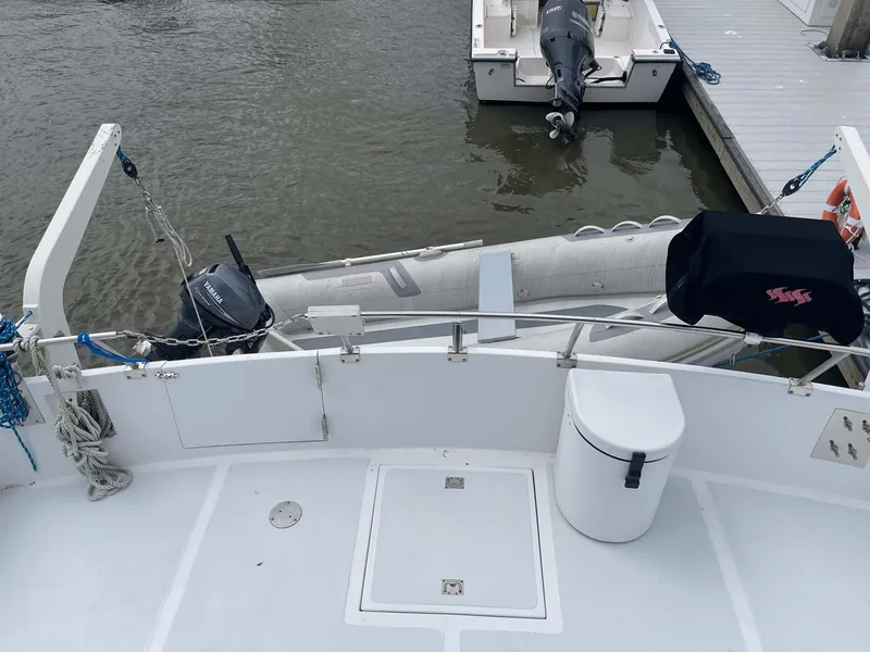 Slide: The Image of 1985 DeFever 40 Offshore Cruiser with dinghy at dockside. - 37