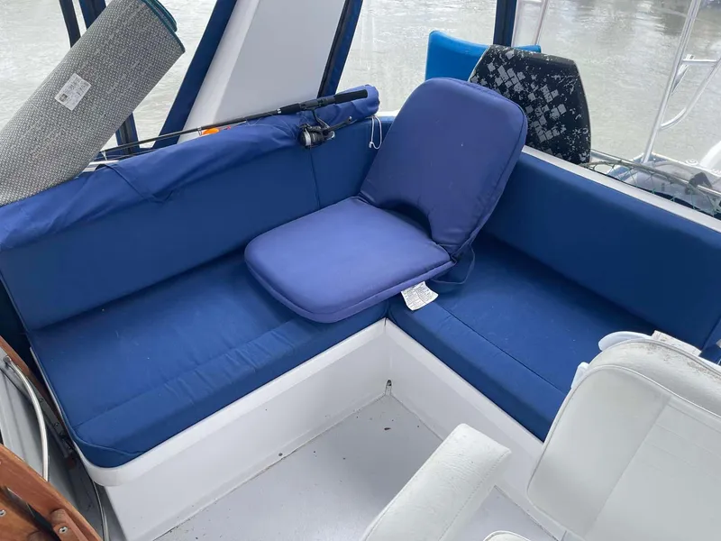Slide: The Image of 1985 DeFever 40 Offshore Cruiser interior with blue cushioned seating. - 44
