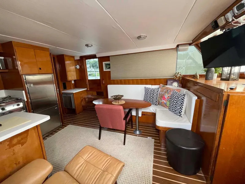 Slide: The Image of 1985 DeFever 40 Offshore Cruiser interior with cozy seating, dining area, and modern kitchen. - 6