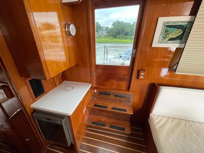 Slide: The Image of Interior of 1985 DeFever 40 Offshore Cruiser with wooden cabinetry and steps. - 8