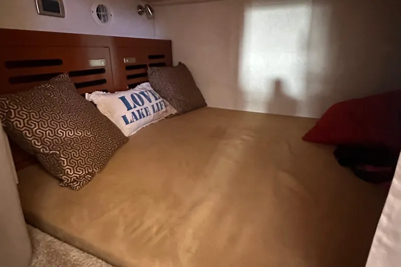 Slide: The Image of Cozy cabin interior of 2010 Sea Ray 310 Sundancer with decorative pillows. - 10