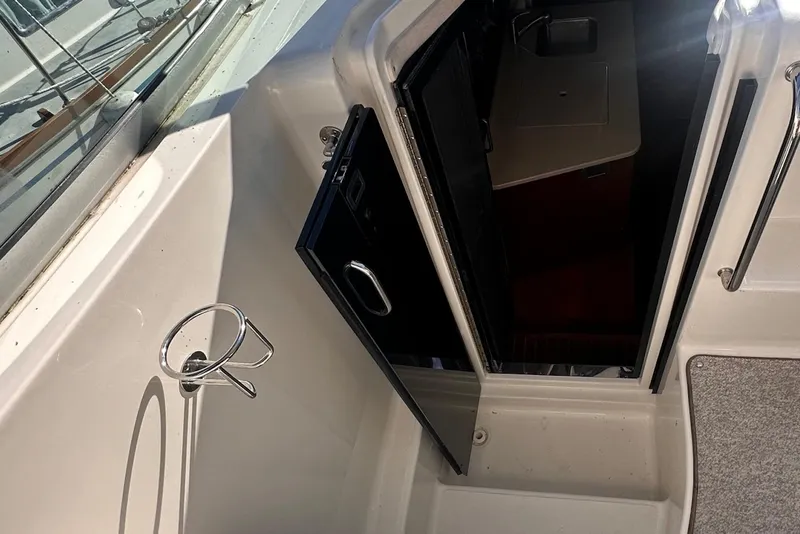 Slide: The Image of 2010 Sea Ray 310 Sundancer cabin entrance with open door and interior view. - 6