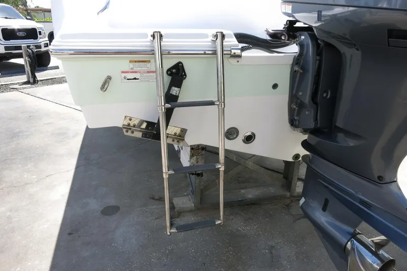 Slide: The Image of 2019 Sportsman Heritage 231 Center Console boat with ladder and outboard motor. - 11