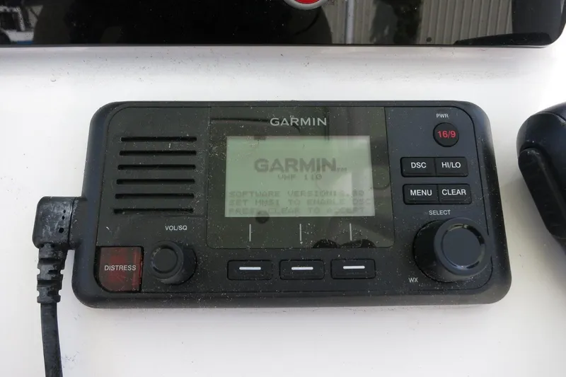 Slide: The Image of Garmin VHF radio on 2019 Sportsman Heritage 231 Center Console boat dashboard. - 13