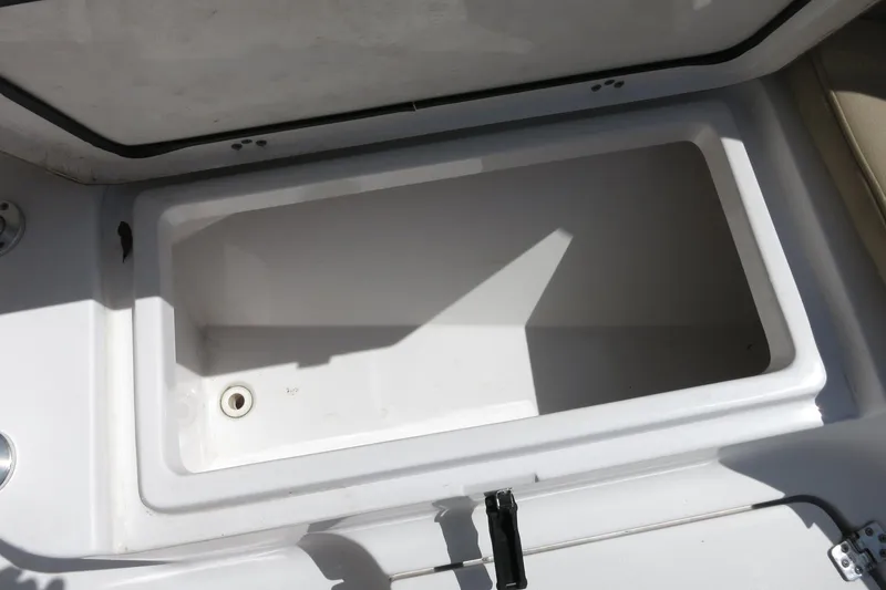Slide: The Image of Open storage compartment on 2019 Sportsman Heritage 231 Center Console boat. - 18