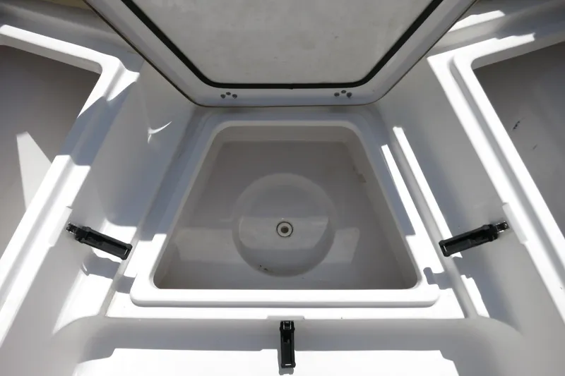 Slide: The Image of 2019 Sportsman Heritage 231 Center Console storage compartment, open and empty. - 19