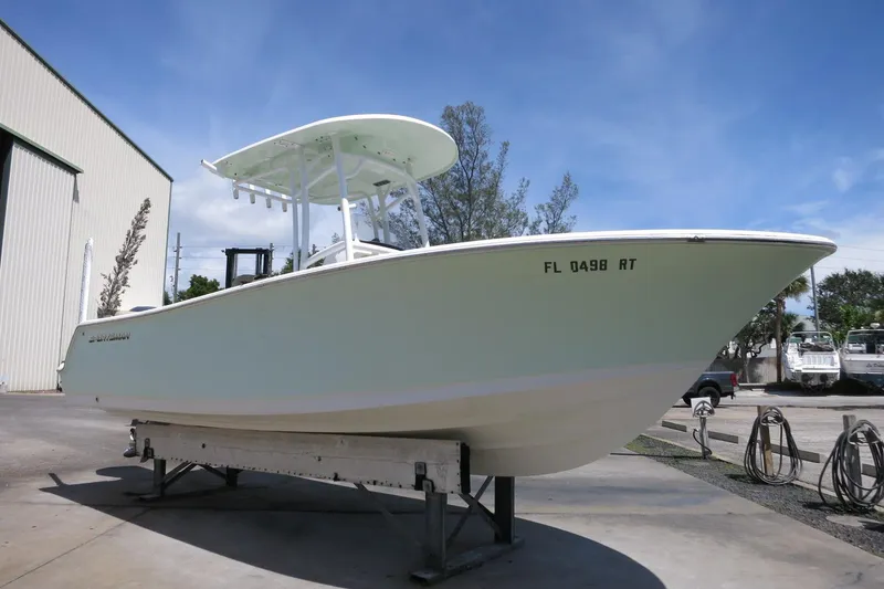 Slide: The Image of 2019 Sportsman Heritage 231 Center Console boat on display outdoors. - 2