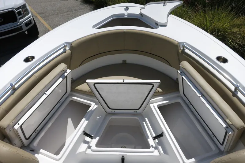Slide: The Image of 2019 Sportsman Heritage 231 Center Console boat with open storage compartments and cushioned seating. - 20