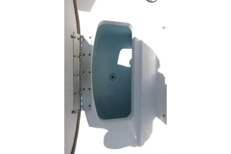 Slide: The Image of 2019 Sportsman Heritage 231 Center Console boat storage compartment, open and empty. - 21