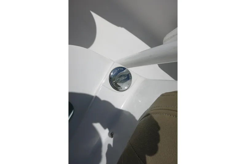 Slide: The Image of 2019 Sportsman Heritage 231 Center Console boat detail with chrome fixture and beige upholstery. - 22