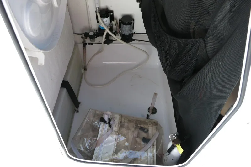 Slide: The Image of 2019 Sportsman Heritage 231 Center Console storage compartment with equipment and netting. - 24
