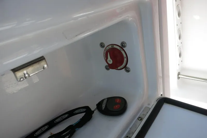 Slide: The Image of 2019 Sportsman Heritage 231 Center Console battery switch and remote control in compartment. - 27