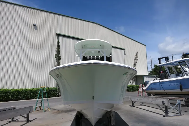 Slide: The Image of 2019 Sportsman Heritage 231 Center Console boat in front of a large warehouse. - 3