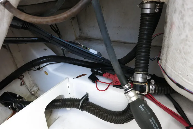 Slide: The Image of 2019 Sportsman Heritage 231 Center Console boat wiring and hoses in the engine compartment. - 31