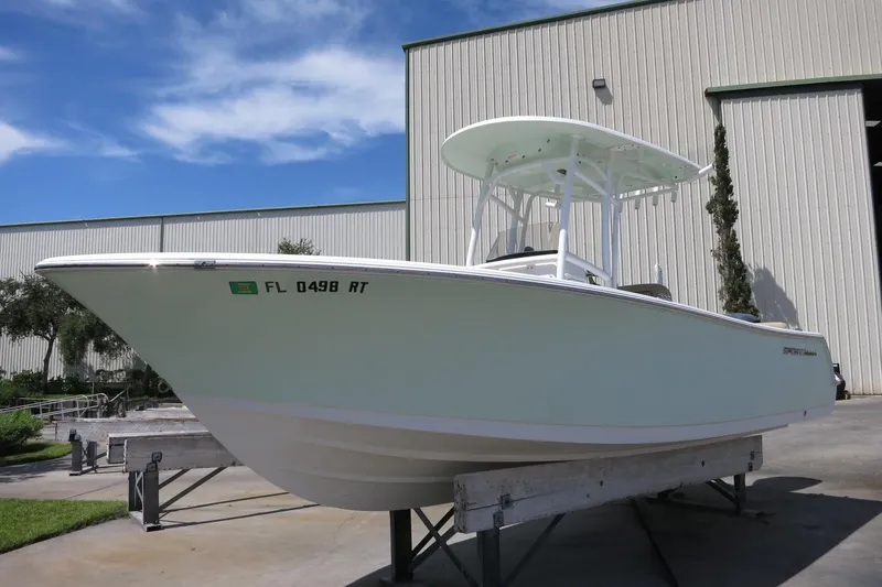 Slide: The Image of 2019 Sportsman Heritage 231 Center Console boat on display outside a warehouse. - 4