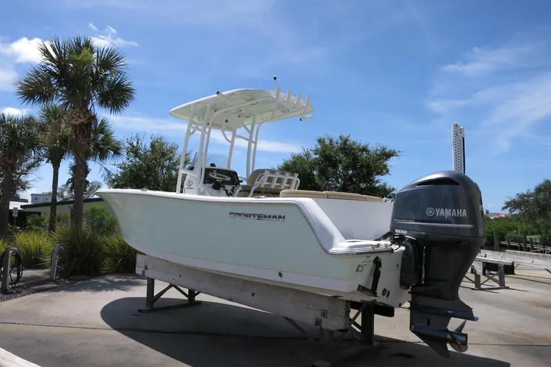 Slide: The Image of 2019 Sportsman Heritage 231 Center Console boat with Yamaha engine, displayed outdoors. - 5