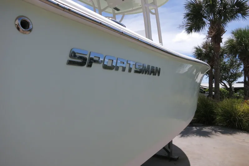 Slide: The Image of 2019 Sportsman Heritage 231 Center Console boat with logo, surrounded by palm trees. - 8