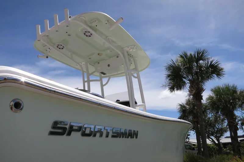 Slide: The Image of 2019 Sportsman Heritage 231 Center Console boat with palm trees and blue sky background. - 9