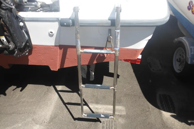 Slide: The Image of Rear view of a 2000 Boston Whaler 18 Ventura Bowrider with a metal boarding ladder. - 12