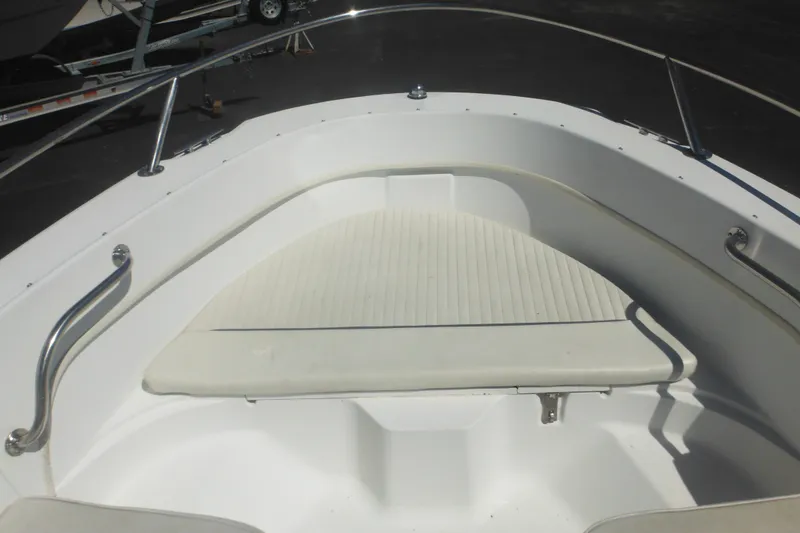 Slide: The Image of 2000 Boston Whaler 18 Ventura Bowrider boat interior with cushioned seating. - 13