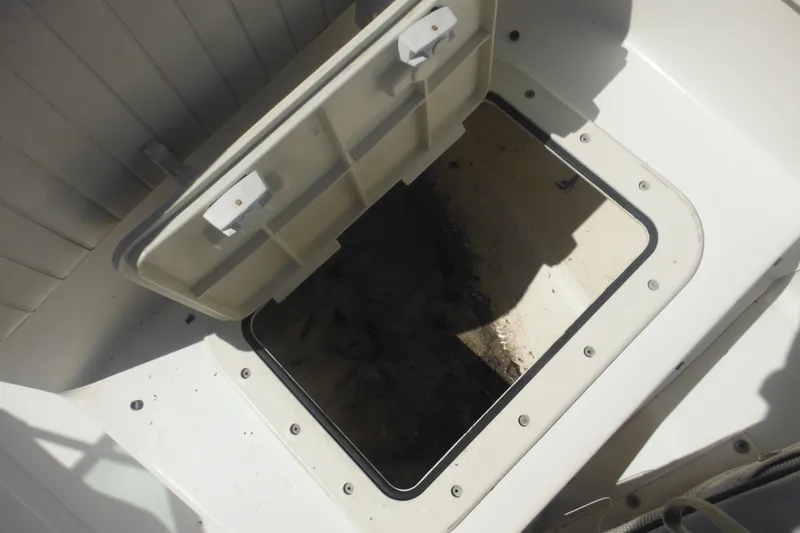 Slide: The Image of Open storage compartment on a 2000 Boston Whaler 18 Ventura Bowrider boat. - 18