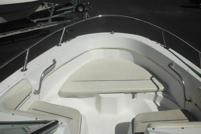 Slide: The Image of 2000 Boston Whaler 18 Ventura Bowrider boat interior with seating and railings. - 19